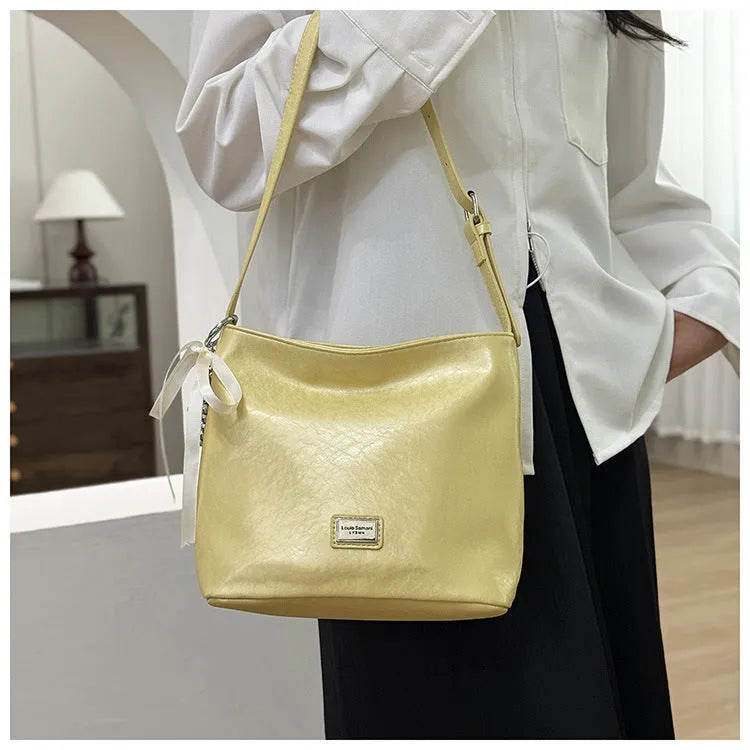 Women's casual crossbody bucket bag in black PU with sandwich pocket and silver hardware