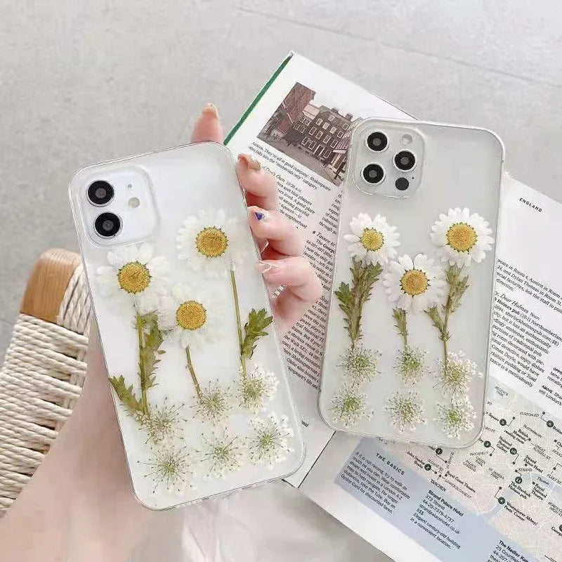 White iPhone case with a raised epoxy daisy floral design on the back.
