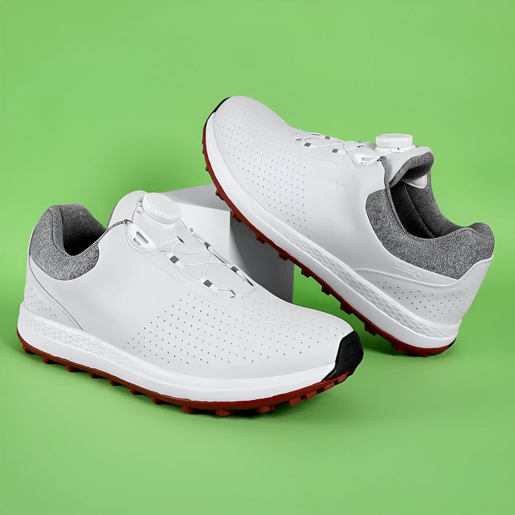 Men's white low top golf sneakers with breathable holes and a textured non-slip sole.