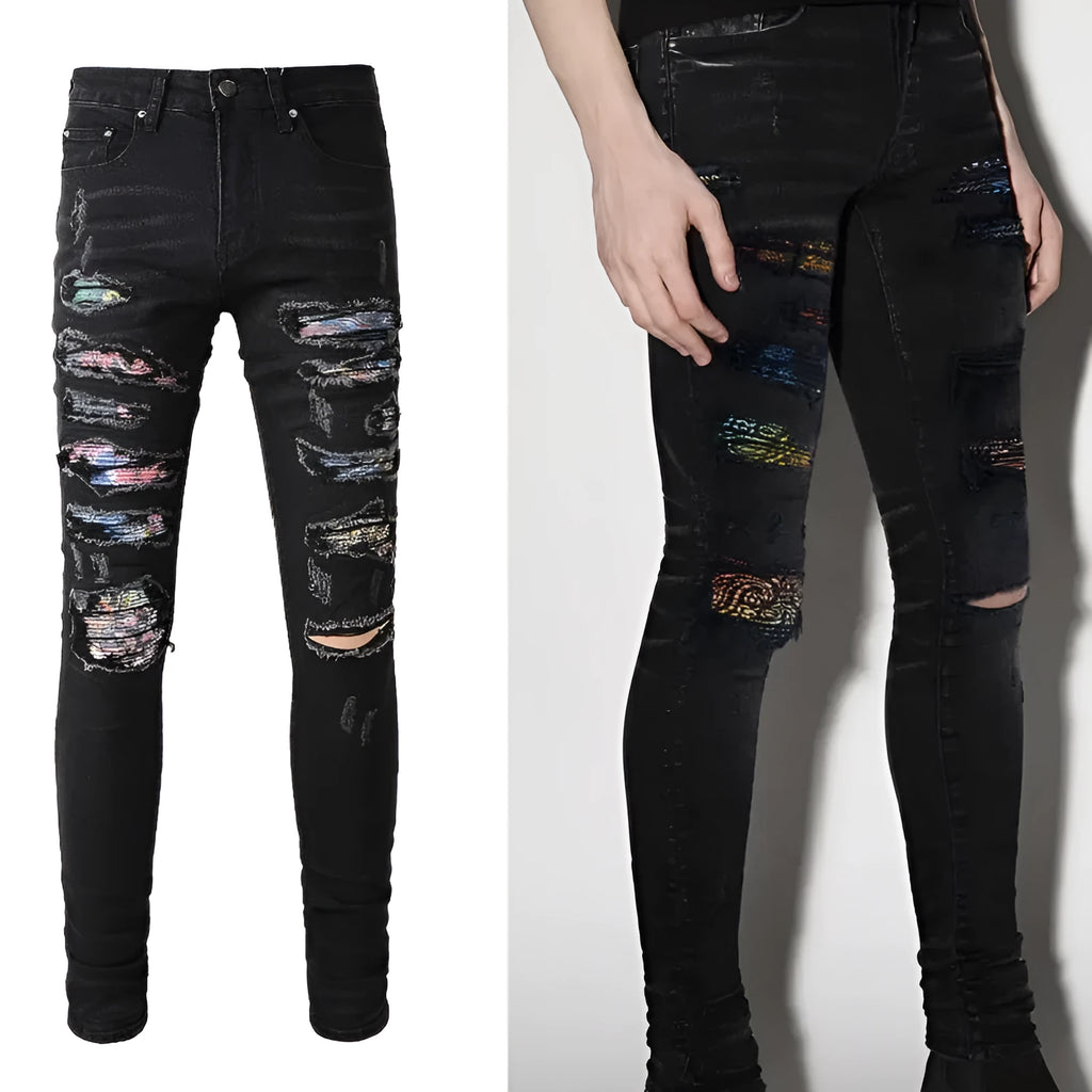 Men's black tattered stretch denim jeans with printed patch on a white background, front view