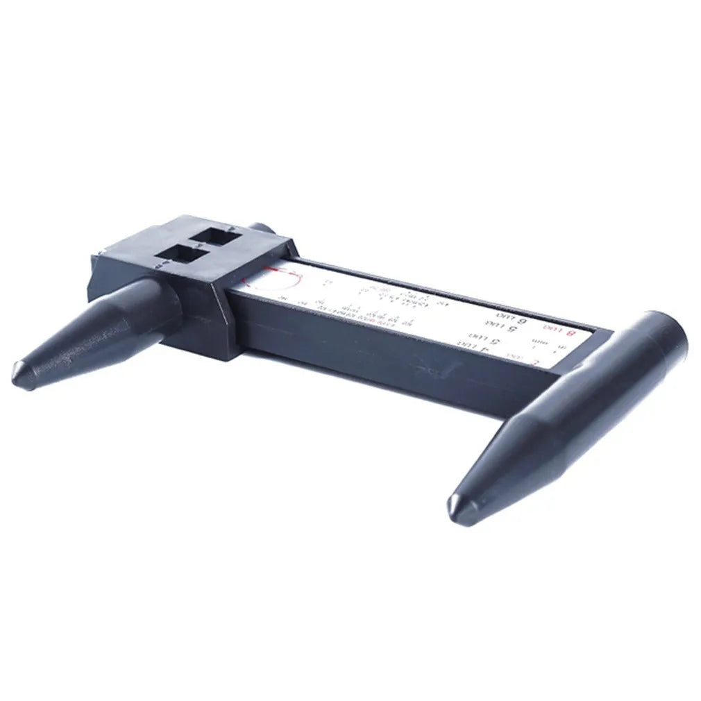 Digital electronic plastic caliper hole distance ruler on a workbench.
