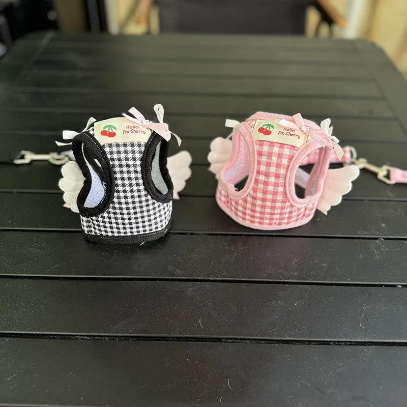 Pink cotton chest and back harness with hand-holding rope for a small dog on a white background.