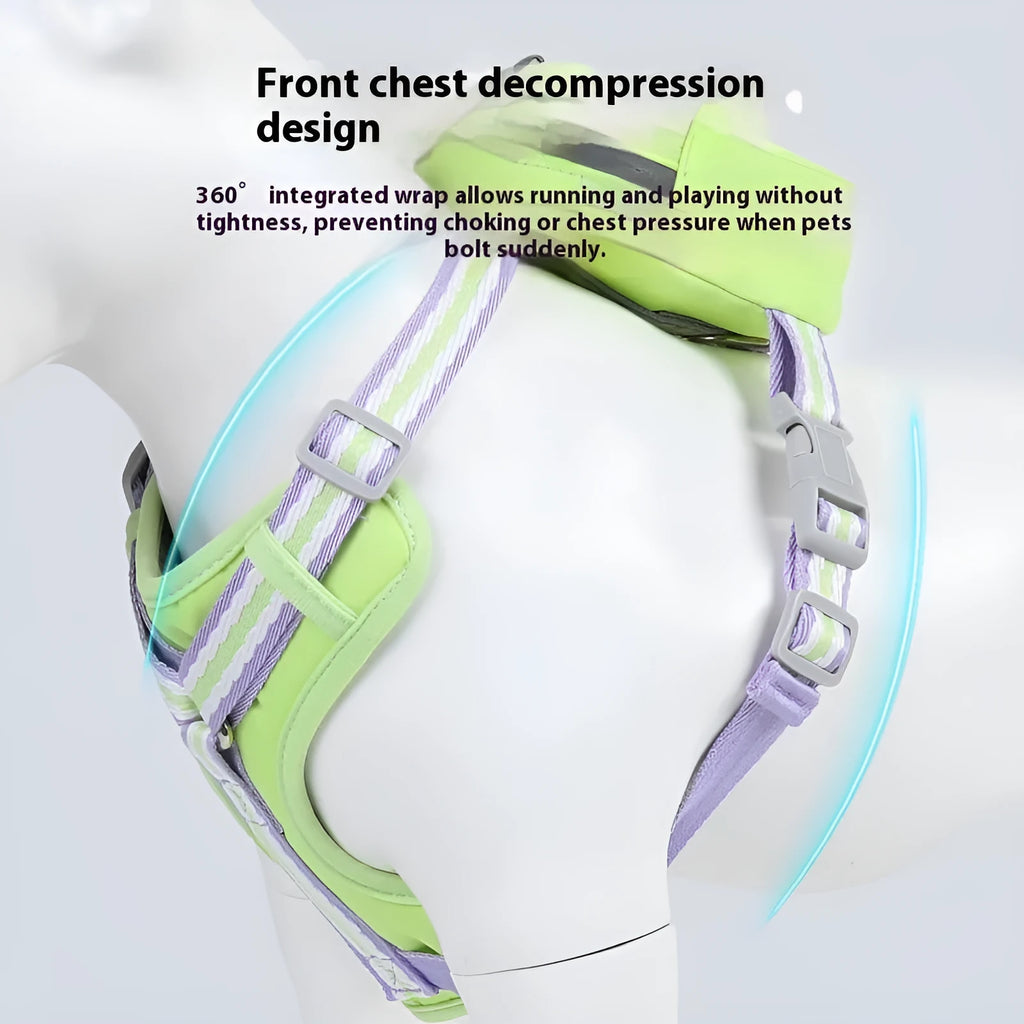 A dog wearing a green Oxford cloth anti-strangulation harness with a metal D-ring and adjustable belly straps.