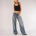 Women's blue cotton wide leg mop trousers with low waist and spliced stitching detail.