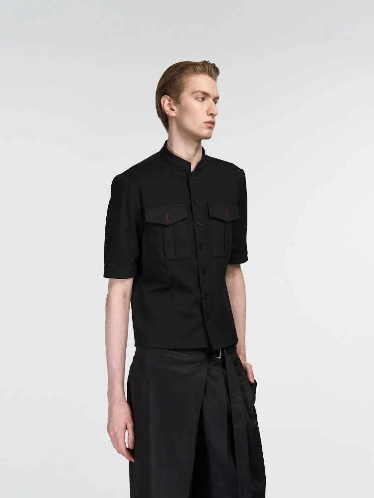 Handmade black loose-fit half sleeve hunting shirt with a shirt collar on a hanger.