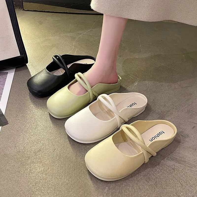 Ladies' plastic summer sandal with toe cap in green, shown from the side.