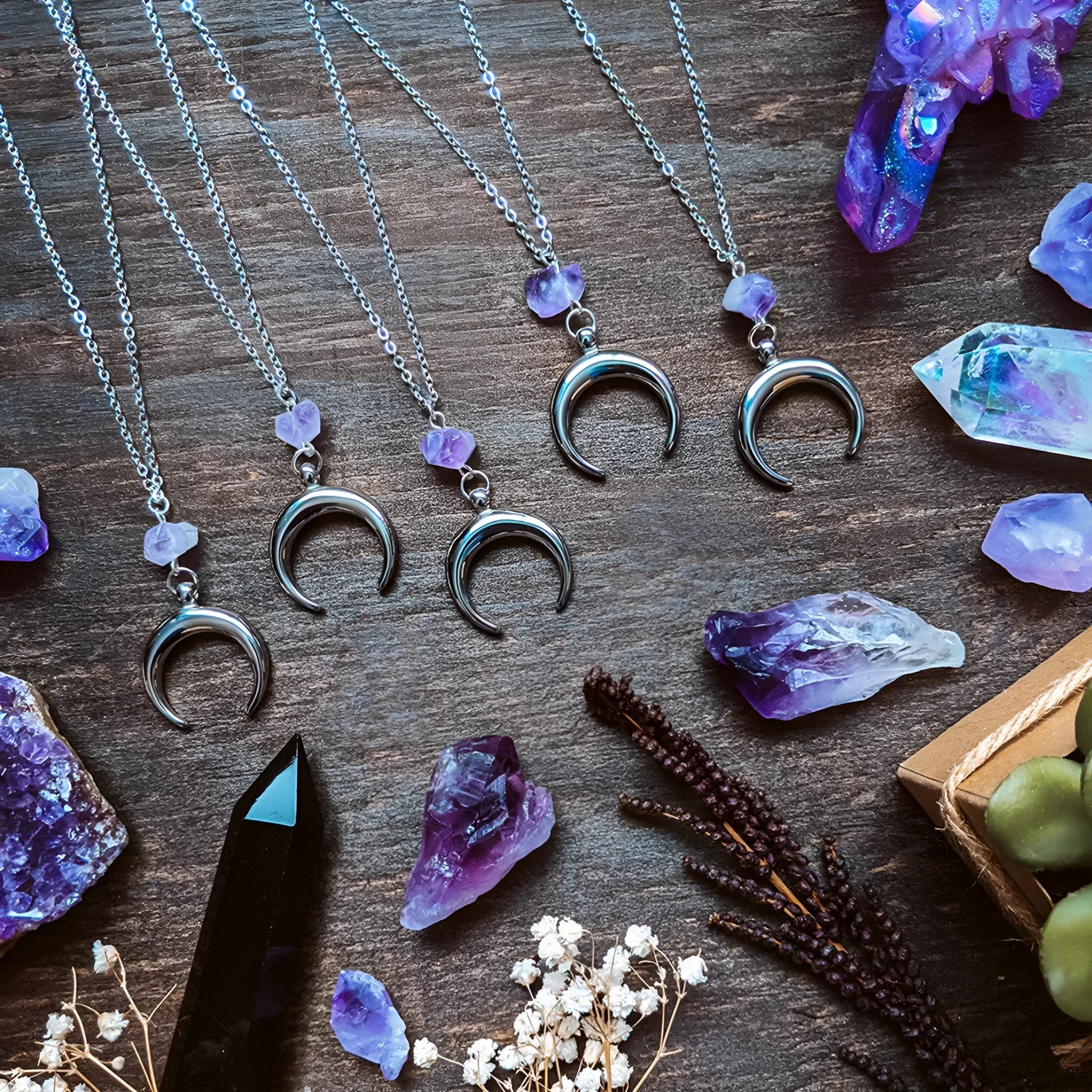 Silver moon-shaped pendant necklace with purple natural crystal centrepiece on alloy chain