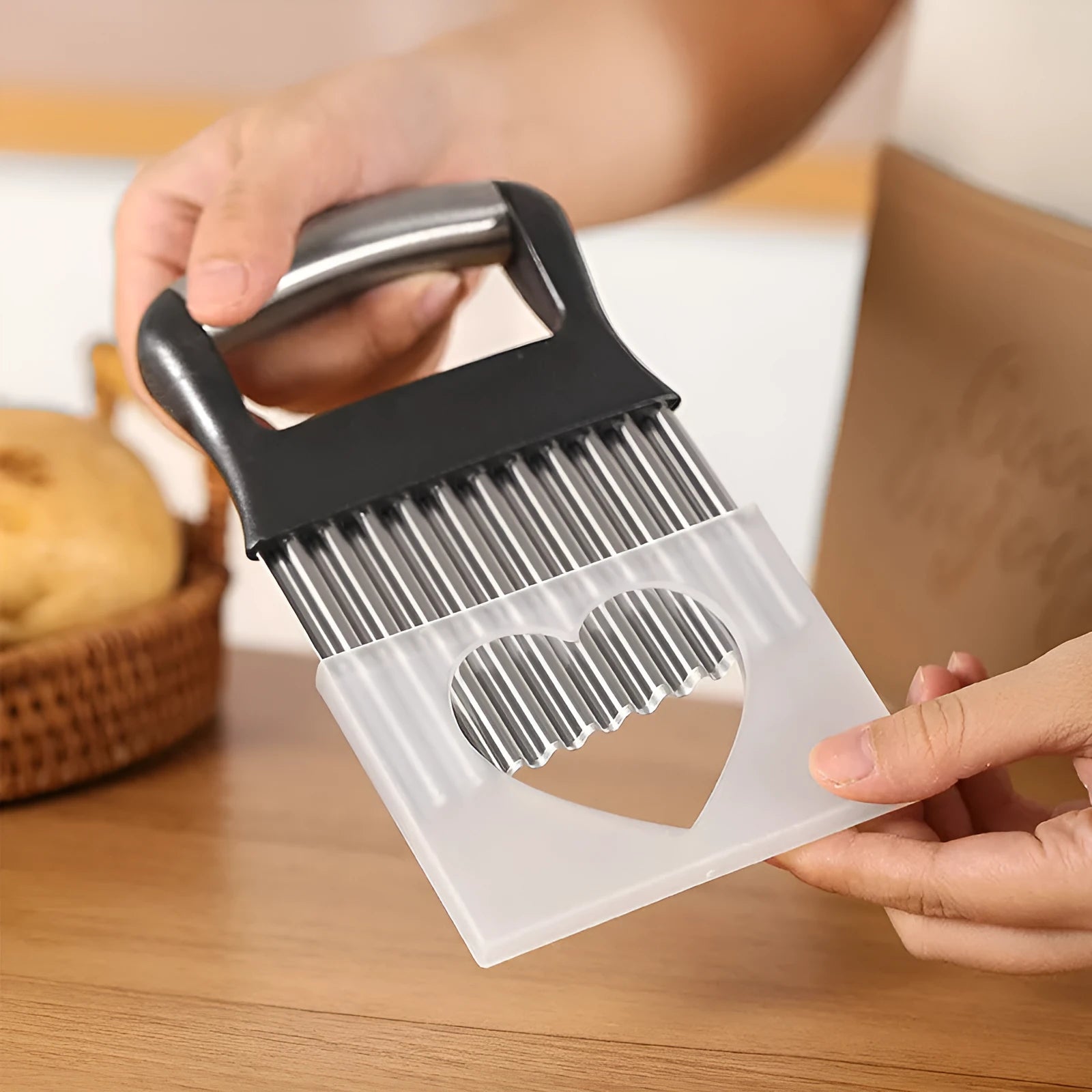 Stainless steel potato wave knife with crinkle-cut blade on a wooden cutting board.