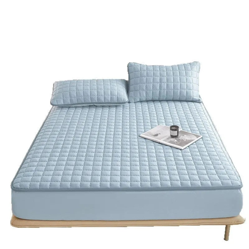 Class A waterproof fitted sheet in washed cotton, shown in a neutral colour on a bed.