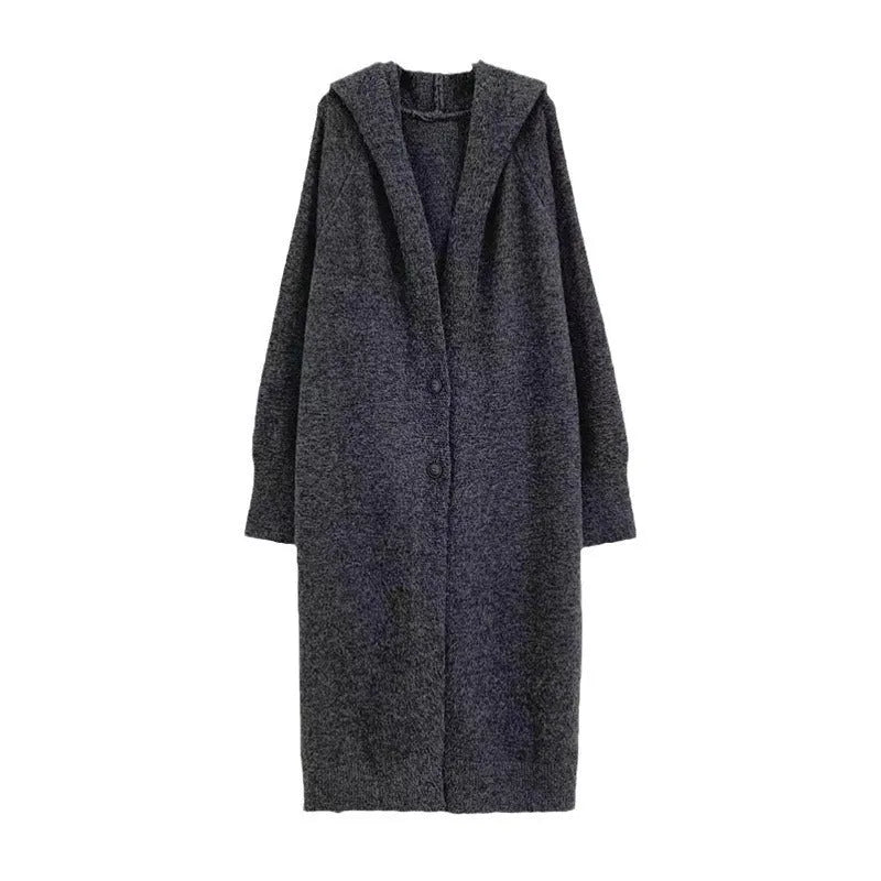 Long beige hooded knitted cardigan on a woman, showcasing its below-the-knee length and loose fit.