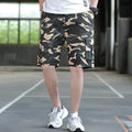 Man modelling loose fit khaki casual trousers with a giraffe pattern gradient detail.