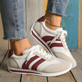 Wine red Cortez retro sneaker with cross straps, mesh lining, and flat rubber sole.
