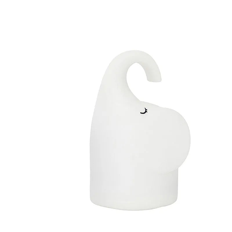 DOMI Elephant silicone night light with warm white glow on a bedside table