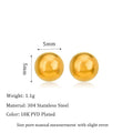 Close-up of minimalist round ball stud earrings in gold and silver finishes on a neutral background.