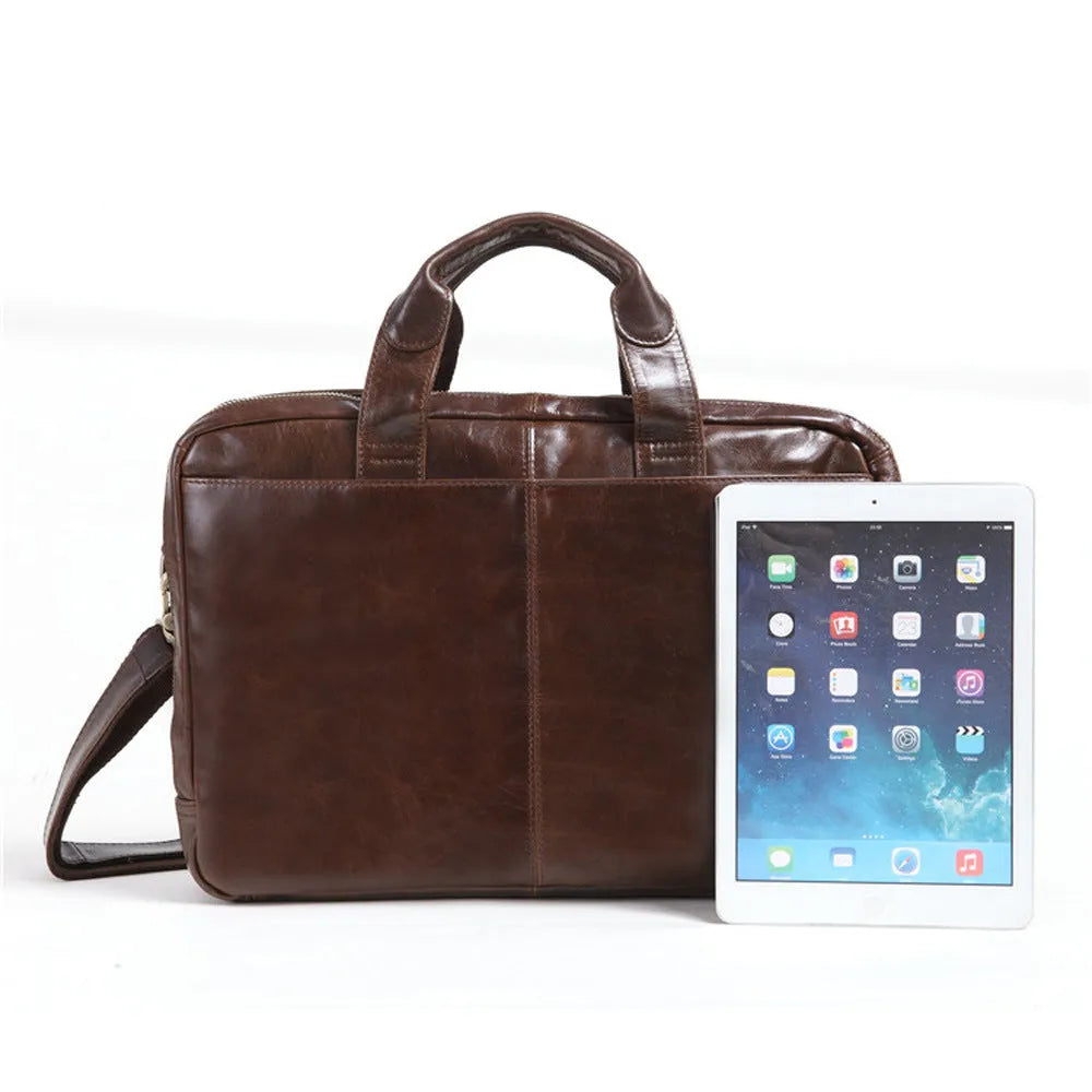 Brown leather men's business briefcase with laptop compartment showing cowhide texture