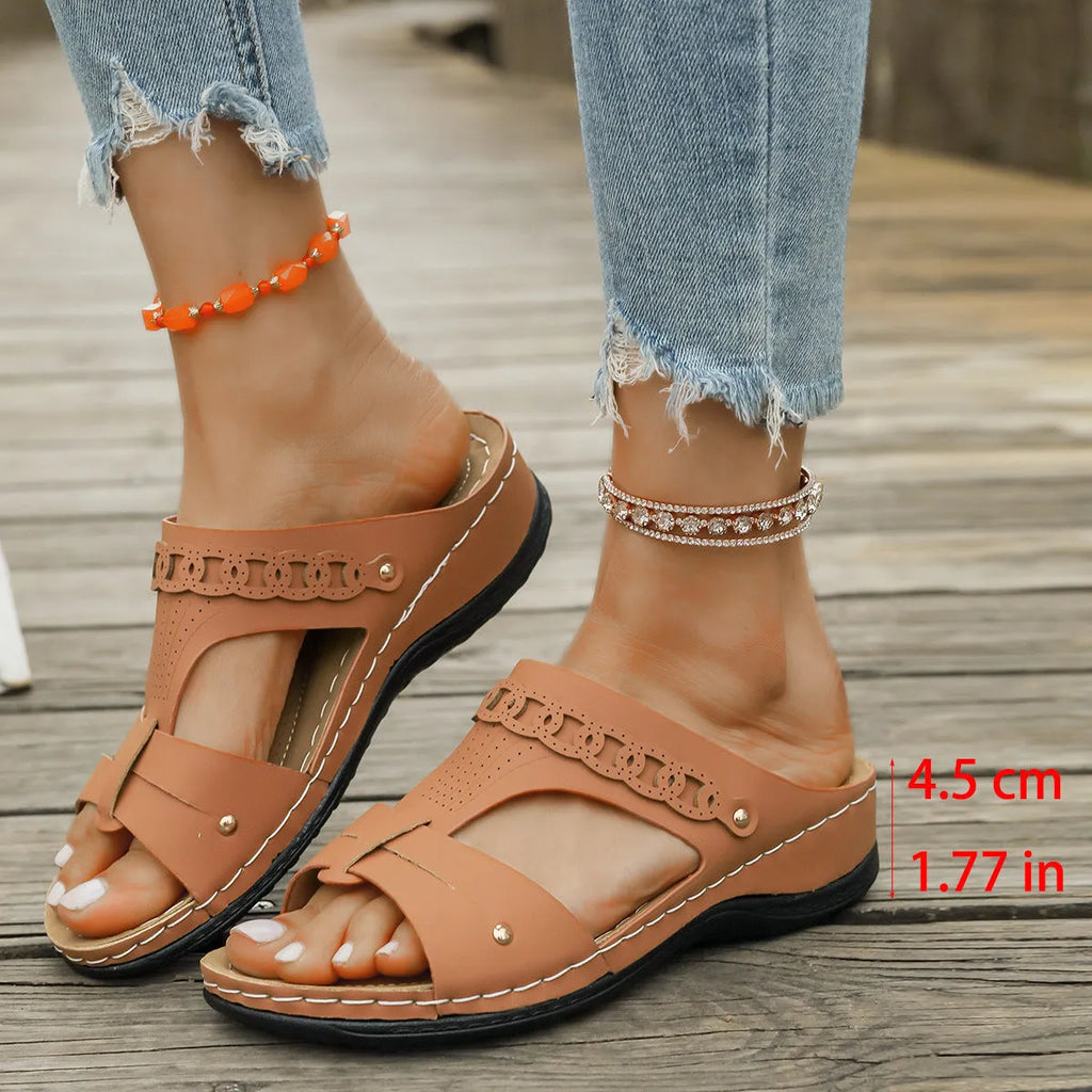 Pair of casual Roman style slippers with a fish mouth toe holder and slope heel, shown in a choice of colours.