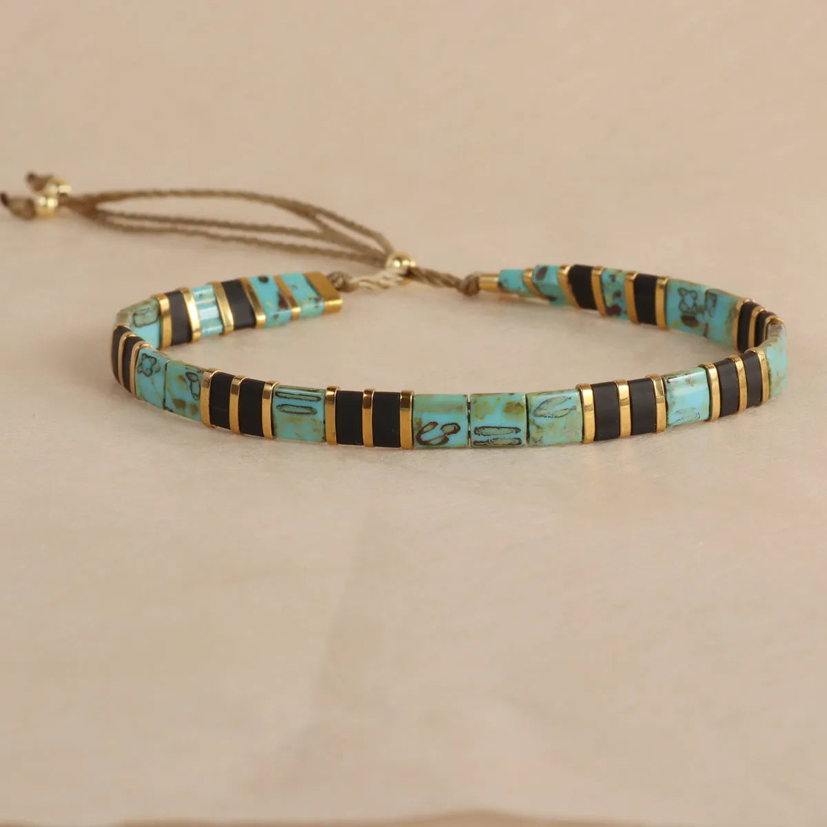 Geometric beaded bracelet with round glass and coloured glaze beads in five colour options.