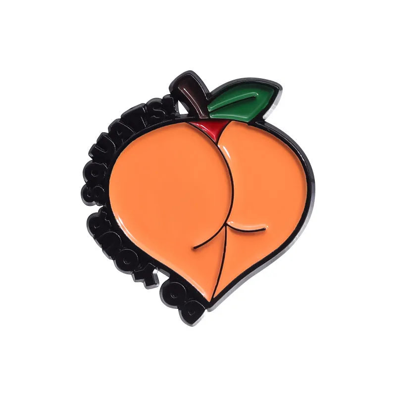 Colourful cartoon-style fruit metal brooch with pin clasp on a denim jacket lapel.