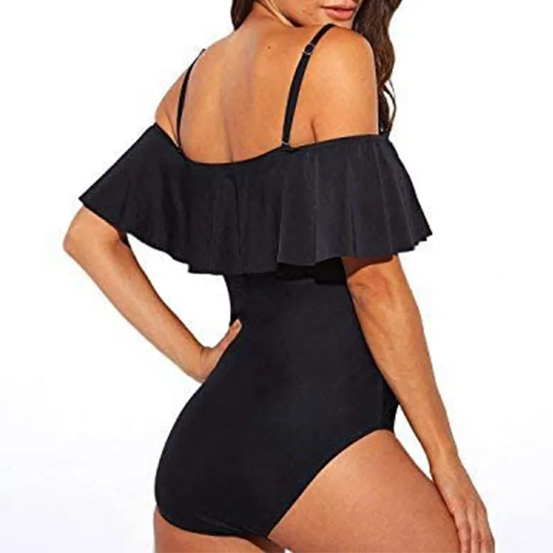 Black one-piece swimsuit with cut-out detail and ruffled strap tube top.