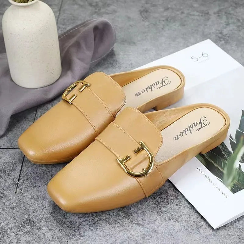 Women's PVC closed toe half slipper in white with a double buckle, shown on a foot.