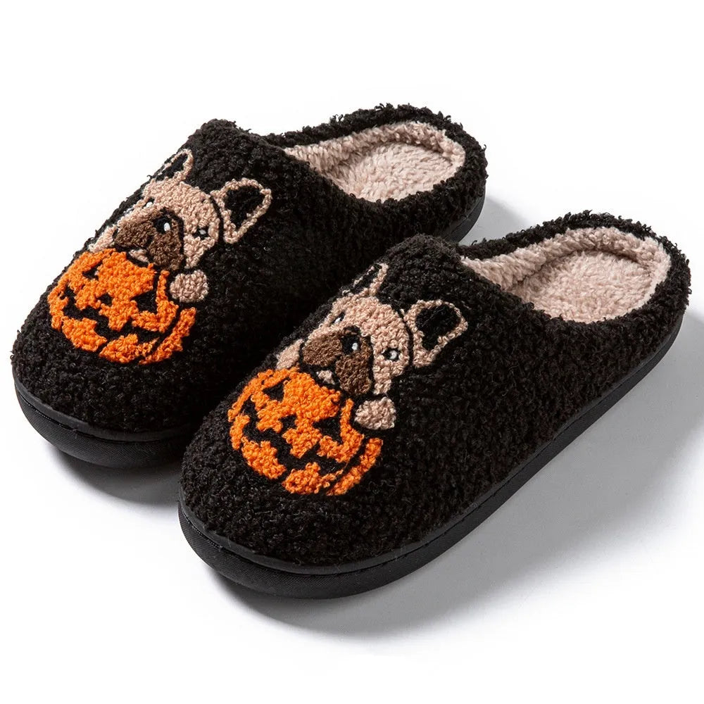Black and white Halloween slippers with pumpkin pattern, plush upper, and textured rubber sole.