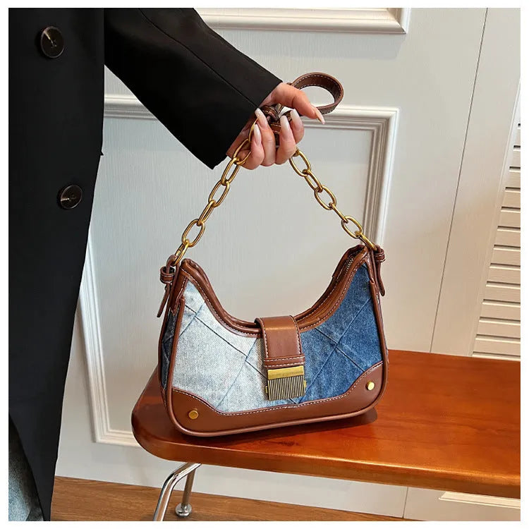 Brown denim women's bucket shoulder bag with diamond mesh detail and a chain strap.