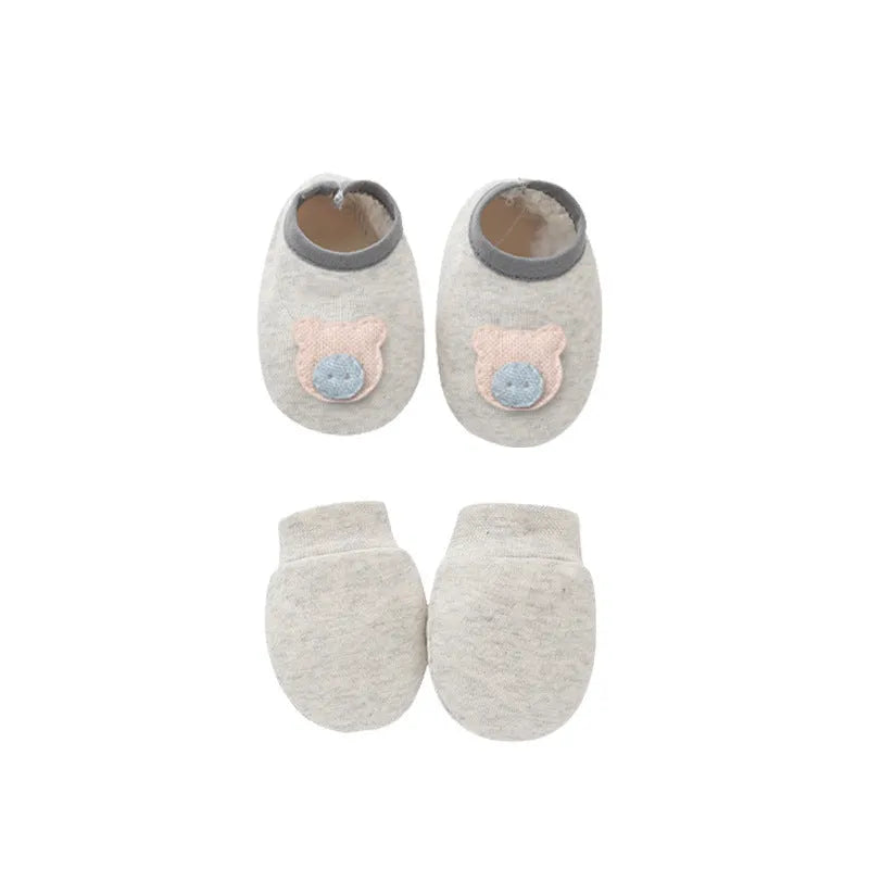 Set of white, light blue, and grey cotton baby pullover caps, gloves, and foot covers for infants.
