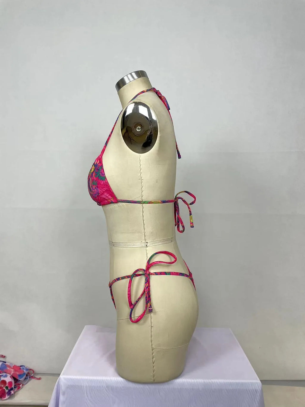 Pink printed women's bikini two-piece set with backless design for swimming.