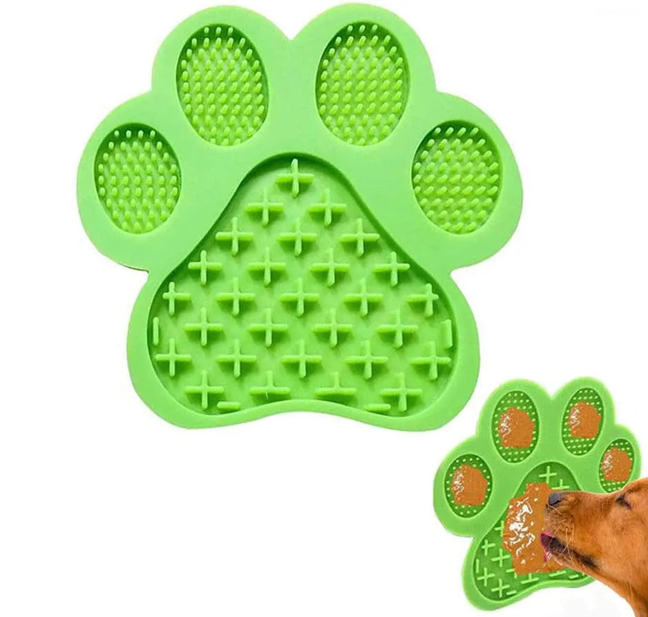 Blue bone-shaped silicone dog licking mat with suction cups on a tiled shower wall.