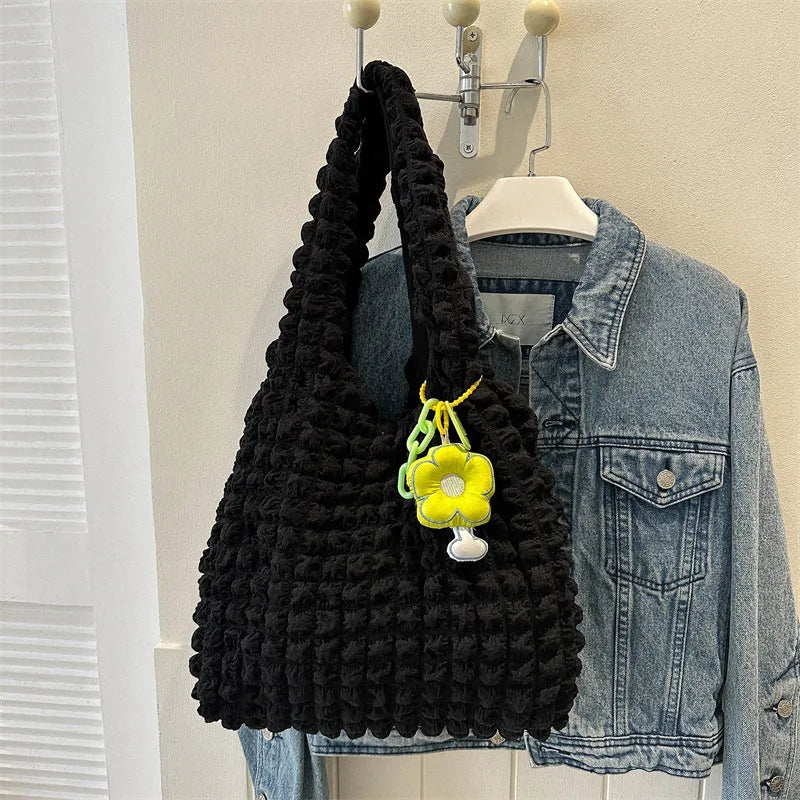 Women's pleated bubble shoulder bag with a floral pendant in soft polyester, shown in a vertical square shape.