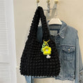 Women's pleated bubble shoulder bag with a floral pendant in soft polyester, shown in a vertical square shape.