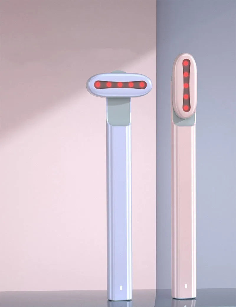 Micro current introduction eye massage instrument in green, with RF gear and USB charging cable on a white background