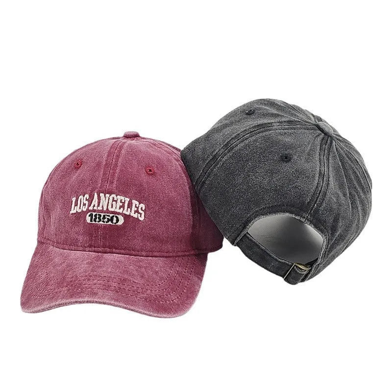 Retro beige personalised washed cotton peaked cap with adjustable strap and embroidered letters on the front.