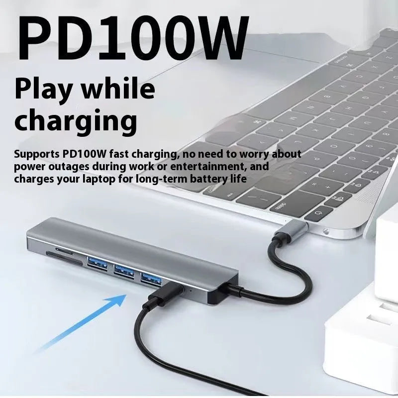 Silver USB Type-C 7-in-1 expansion dock with HDMI port and 15cm attached cable on a desk.