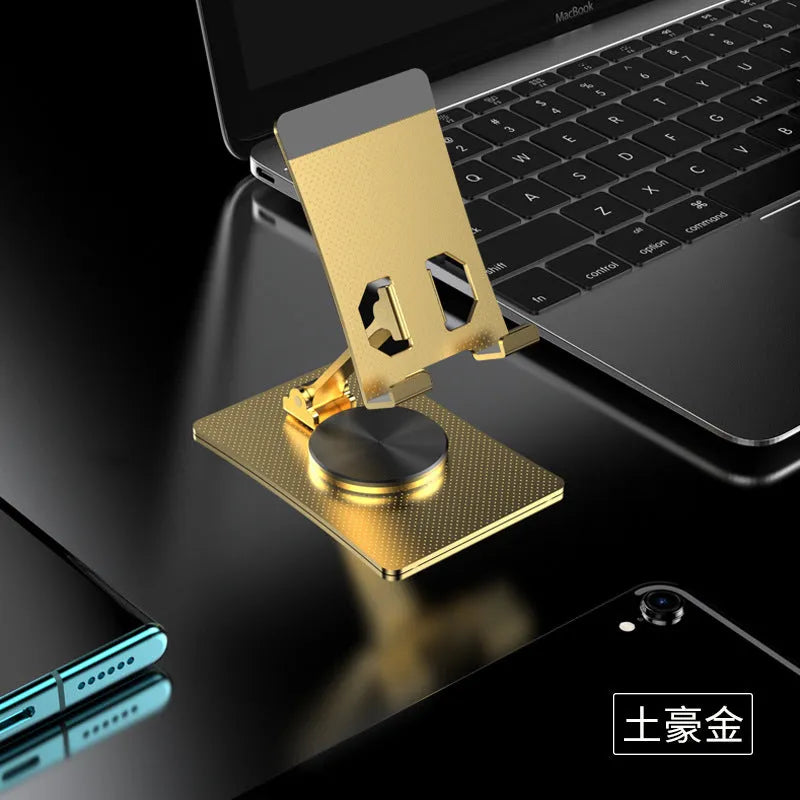 Aluminium alloy rotating mobile phone bracket in silver on a desk, showing three-axis joint and metal texture finish