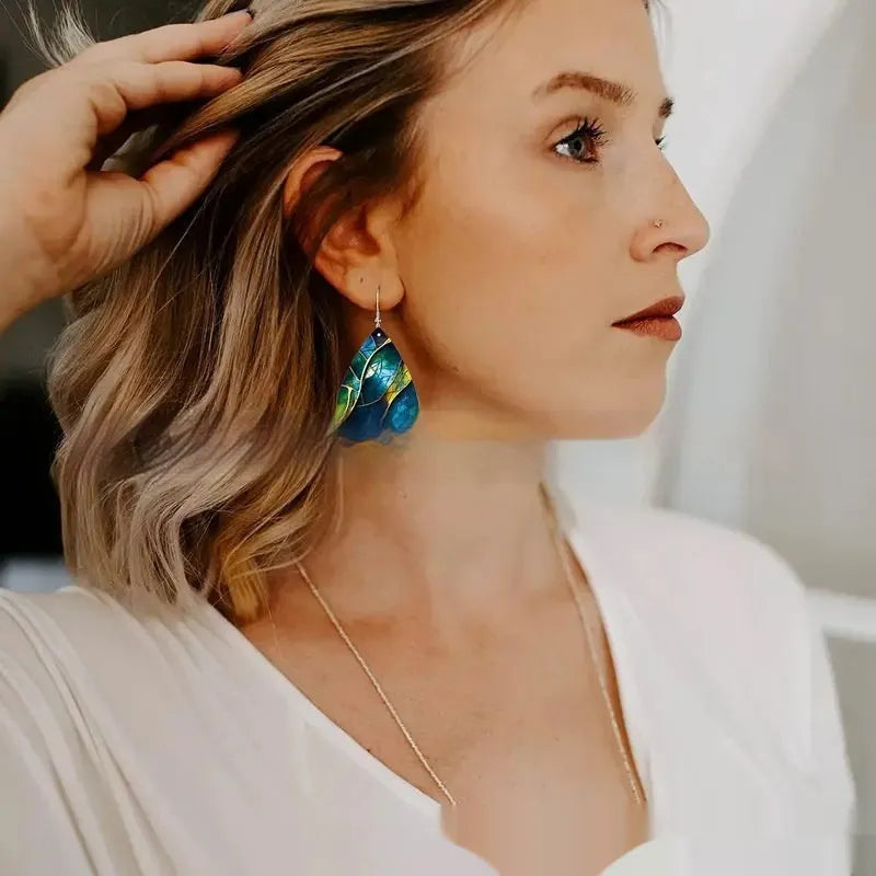 Printed acrylic drop earrings with flat branch knot geometric design on white background