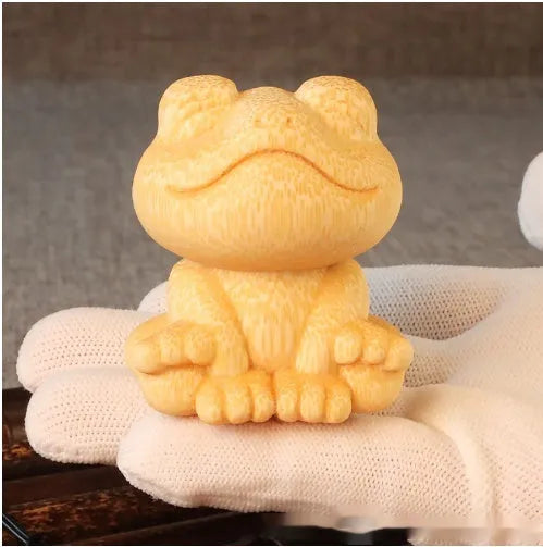 Solid bamboo carving ornament of a smiling frog, 5cm high, cute cartoon style.