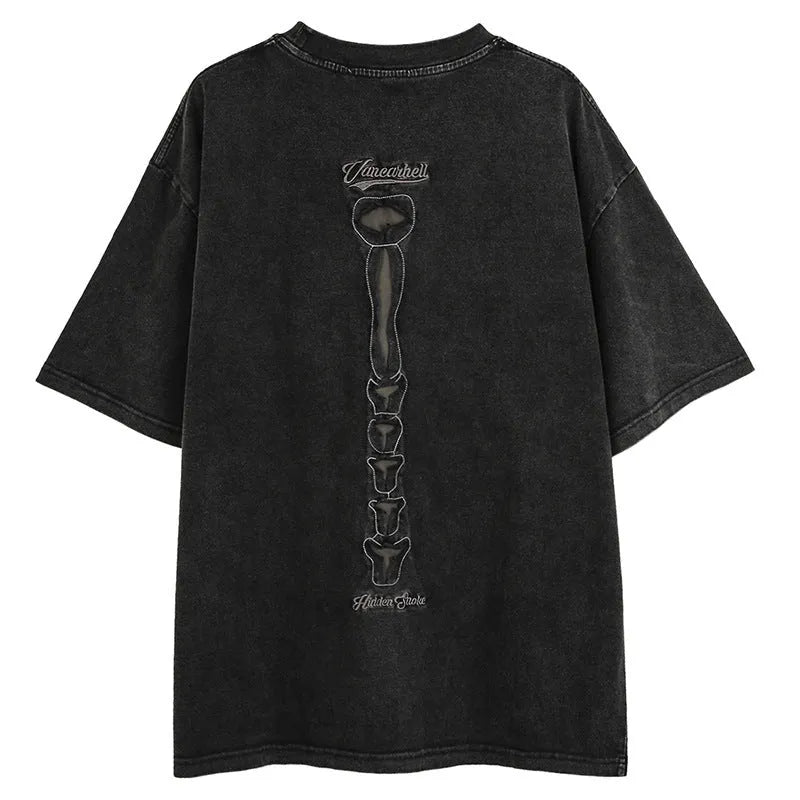 Man wearing a black loose-fit cotton pullover with a skull and letter graphic print and drop-shoulder sleeves.