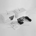 Black 4K USB webcam with attached cable and a magnetic privacy cover on a desk.