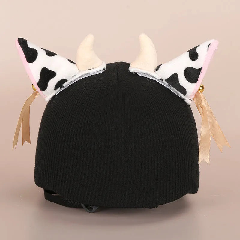 A soft plush cartoon character cover stretched over a medium-sized motorcycle helmet.