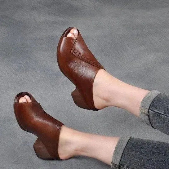 A pair of women's black square heel peep-toe slippers with an open fish mouth design.