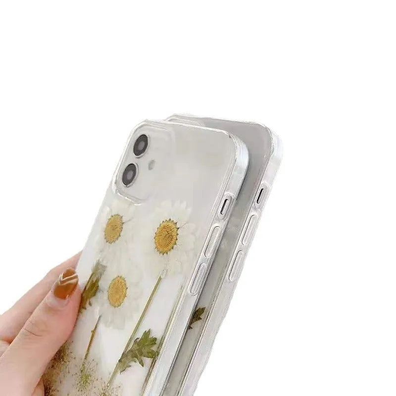 White iPhone case with a raised epoxy daisy floral design on the back.