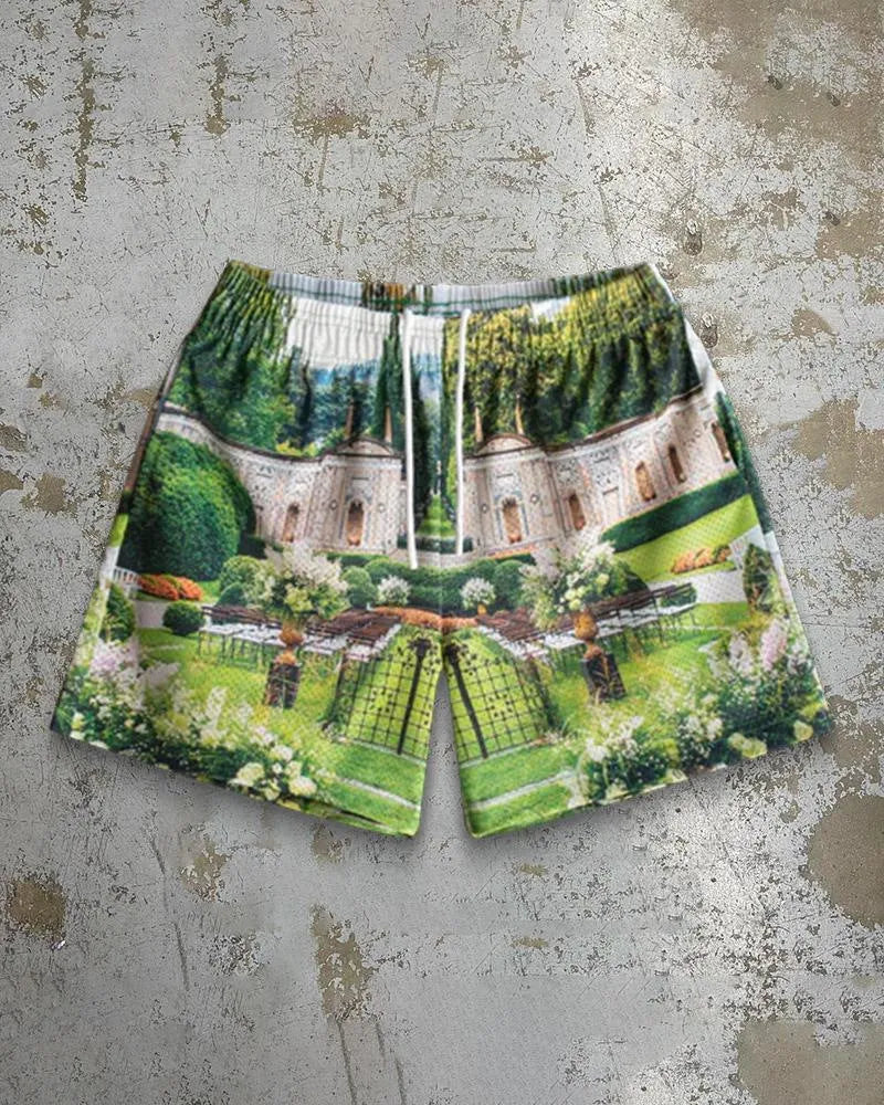 Man wearing loose blue digital print beach shorts made from quick-dry milk silk polyester fabric.