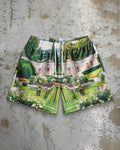 Man wearing loose blue digital print beach shorts made from quick-dry milk silk polyester fabric.