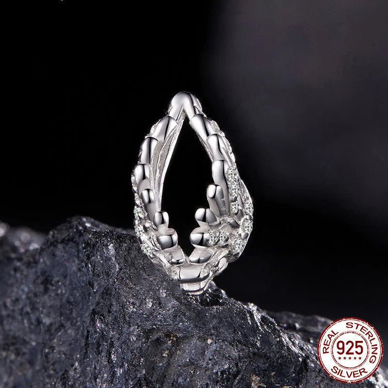 S925 sterling silver wing bead inlaid with zircon on a white background showing 1.4cm size
