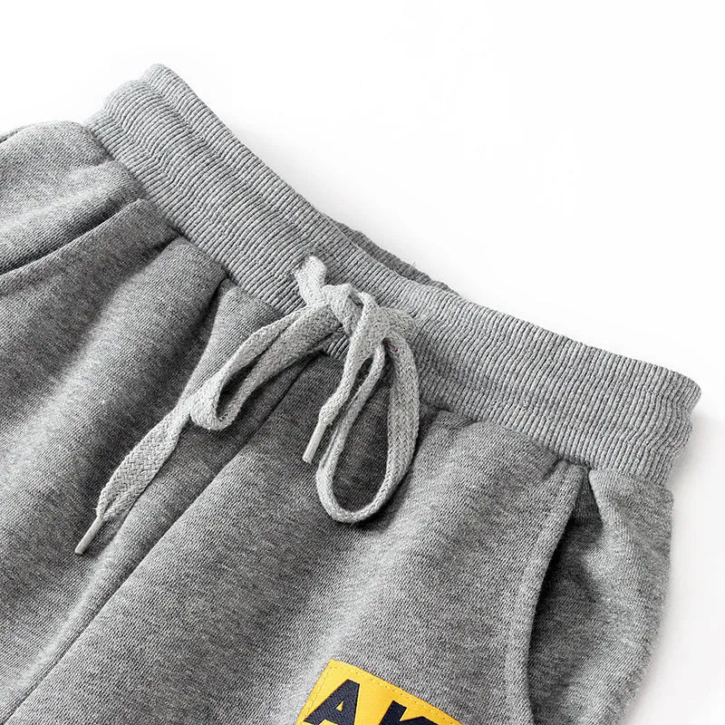 Boys' cotton track pants in black and grey, sizes 120-160cm, with elasticated hips