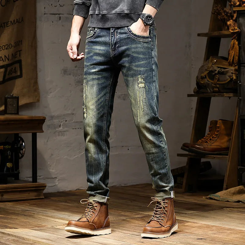 Men's skinny fit jeans in a retro blue wash with a zip fly, shown laid flat.