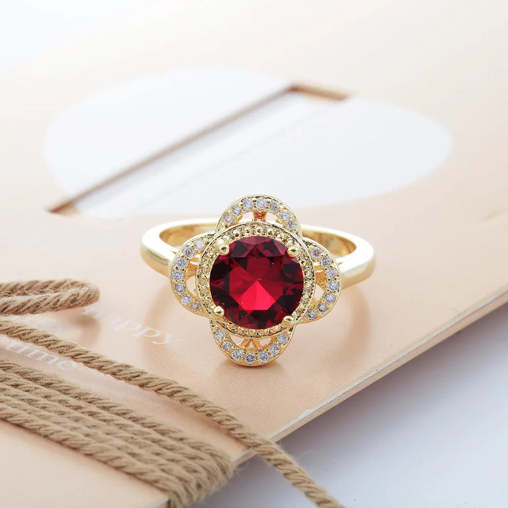 Copper fruit-shaped ring with a zircon stone, shown on a finger.