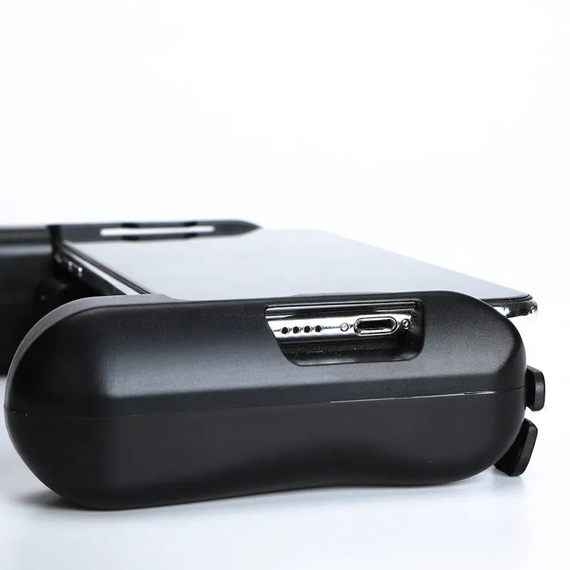 Black Bluetooth gaming controller for Apple iPhone on a table.