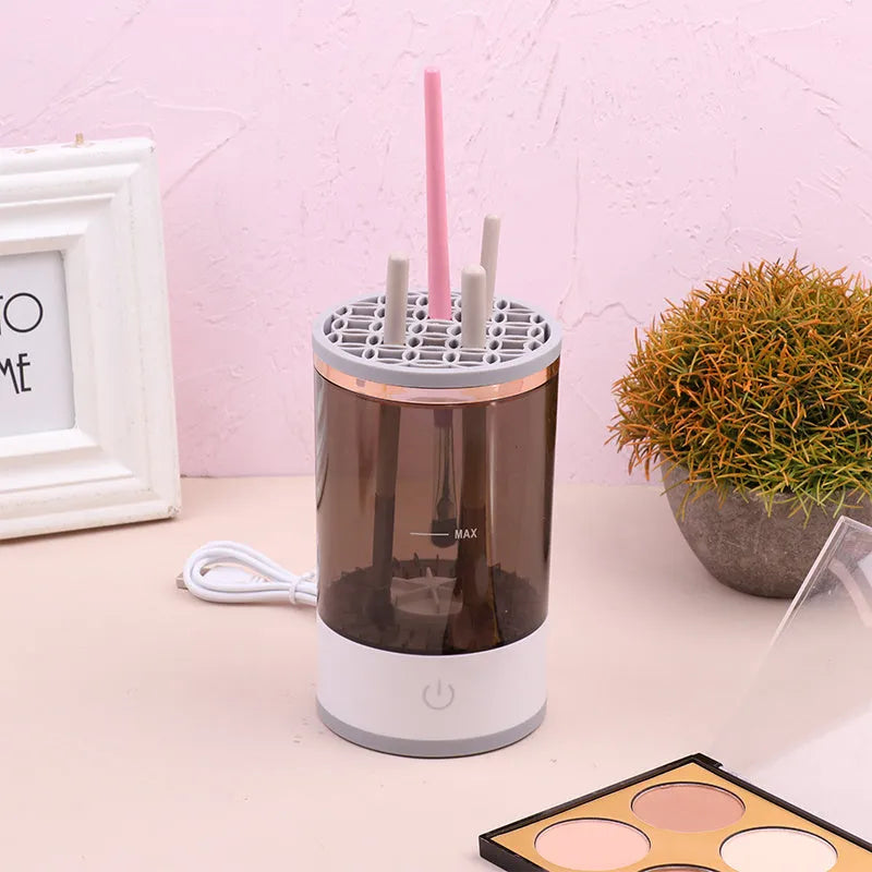 Grey and white portable electric makeup brush cleaner with USB cable.